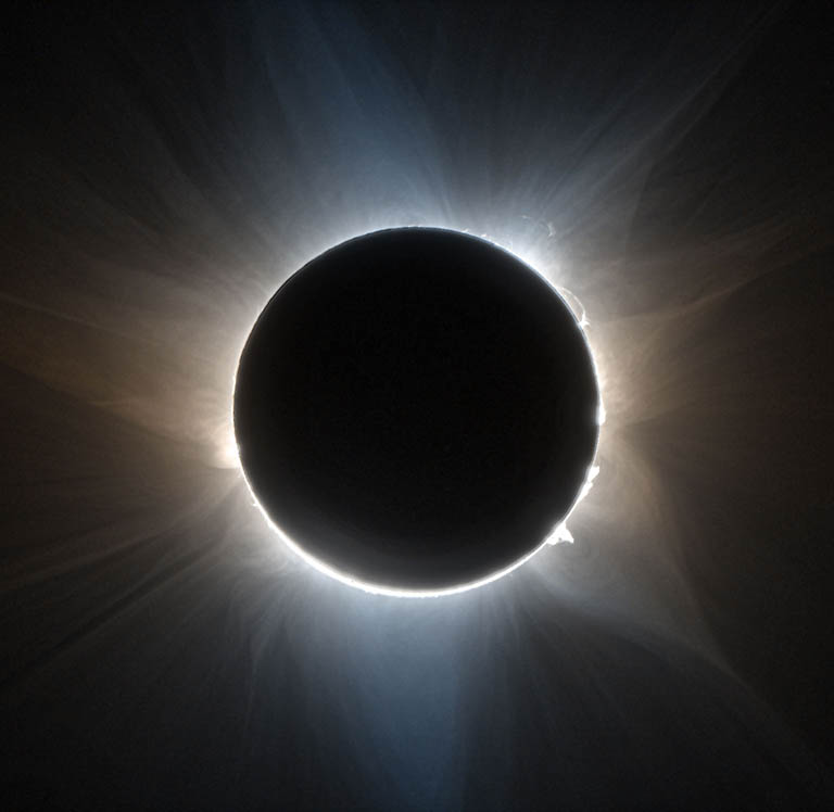 Image Caption & Credit: The Citizen CATE 2024 project produced this false color image of the solar corona during the 2023 total solar eclipse from Exmouth, Western Australia. The image combines two crossed polarization angles, indicated by color. Prominences, loops and streamers are easily visible in this high-resolution image. (Credit: Courtesy of SwRI/Citizen CATE 2024/Dan Seaton)